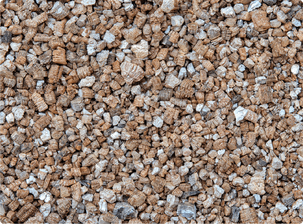 Close-up view of a large pile of small, dry brown and gray pellets, possibly animal feed or pet food, filling the entire frame—unrelated to asbestos removal Madison services.
