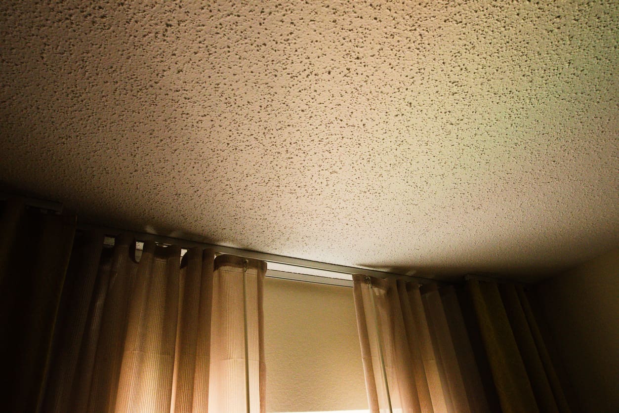 Textured ceiling with brown curtains