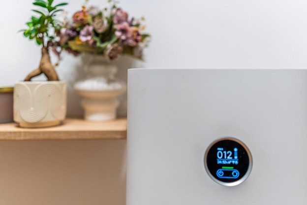 Air purifier on shelf with plants